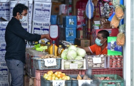 A man seen making a transaction at the local market in capital city Male'. PHOTO: NISHAN ALI / MIHAARU
