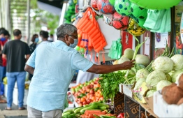 A middle-aged man captured shopping in reclaimed suburb Hulhumale'. PHOTO: NISHAN ALI / MIHAARU