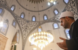 An imam attends the Eid al-Fitr prayers, at the Grand Mosque in Pristina on May 24, 2020, as mosques are still closed to public events a preventive measure against the COVID-19 novel coronavirus. (Photo by Armend NIMANI / AFP)