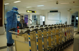 (FILE) Photo of a MACL employee on May 25, 2020, working at the airport in full PPE: when MACL last paid their employees bonuses in 2019, each employee received MVR 8,000 -- Photo: MACL
