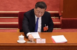 Chinese President Xi Jinping votes on a proposal to draft a security law on Hong Kong during the closing session of the National People's Congress at the Great Hall of the People in Beijing on May 28, 2020. - China's rubber-stamp parliament endorsed plans May 28 to impose a national security law on Hong Kong that critics say will destroy the city's autonomy. PHOTO: NICOLAS ASFOURI / AFP