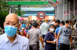People look for bargain items at Chatuchak flea market in Bangkok on May 30, 2020. - Thailand continued easing restrictions related to the COVID-19 novel coronavirus by allowing various businesses to reopen. PHOTO: MLADEN ANTONOV / AFP