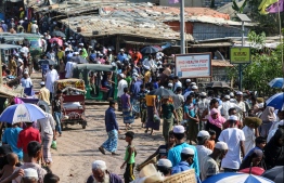 (FILES) In this file photo taken on May 15, 2020 Rohingya refugees gather at a market as first cases of COVID-19 coronavirus have emerged in the area, in Kutupalong refugee camp in Ukhia.  (Photo by Suzauddin RUBEL / AFP)