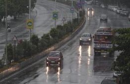 Commuters drive along Marine Drive as rain falls in Mumbai on June 3, 2020 as cyclone Nisarga barrels towards India's western coast. - Mumbai authorities shut offices, banned small gatherings and told people to stay home on June 3 as the Indian megacity's first cyclone in more than 70 years approached. Cyclone Nisarga was expected to make landfall near the coastal town of Alibag, around 100 kilometres (60 miles) south of Mumbai, on June 3 afternoon, forecasters said. PHOTO: PUNIT PARANJPE / AFP