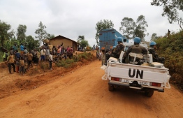 (FILES) In this file photograph taken on March 13, 2020, Moroccan soldiers from the UN mission in DRC (Monusco) ride in a vehicle as they patrol in the violence-torn Djugu territory, Ituri province, eastern DRCongo. - Sixteen civilians, five of them children, were killed late June 2, 2020, in a fresh massacre in the eastern DR Congo province of Ituri, a local official and a UN source said. "The toll, which is still provisional, is of 16 people killed by knives or gunfire. The people killed are four men, seven women and five children all aged under five," the administrator of Djugu territory, Adel Alingi, told AFP on June 3. (Photo by SAMIR TOUNSI / AFP)