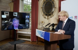 A handout image released by 10 Downing Street, shows Britain's Prime Minister Boris Johnson (R) listening to billionaire philanthropist Bill Gates via zoom during the the Global Vaccine Summit hosted  from 10 Downing Street in central London on June 4, 2020. - British Prime Minister Boris Johnson hosts a vaccine fundraising summit on Thursday under the shadow of coronavirus. The virtual meeting aims to raise $7.4 billion for immunisation programmes stalled by the pandemic, and will see the launch of a new fundraising drive to support potential COVID-19 vaccines. (Photo by Andrew PARSONS / 10 Downing Street / AFP) / 
