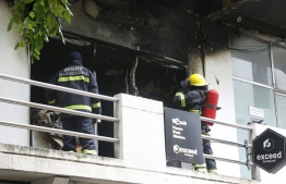 Firefighters putting out the blaze that erupted in Exceed Shop on Majeedhee Magu, Male', on Saturday afternoon. PHOTO: MNDF