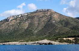 This picture taken from a boat on May 31, 2020 shows a view of a hilltop near Manolis Bay within the larger in Chrysochous Bay by the Akamas peninsula on the western edge of Cyprus. - Cyprus opens back up for international tourism on June 9, with airports welcoming visitors after an almost three-month shutdown, and a bold plan to cover health care costs for visitors. But with arrivals expected to be down by 70 percent this year due to the chaos brought by the COVID-19 pandemic, it's a leap of faith for the small Mediterranean holiday island. (Photo by Amir MAKAR / AFP)