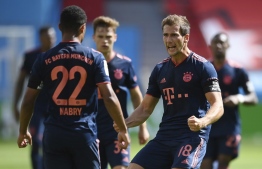 Bayern Munich's German midfielder Serge Gnabry (L) celebrates with Bayern Munich's German midfielder Leon Goretzka after scoring his team's third goal during the German first division Bundesliga football match Bayer 04 Leverkusen v FC Bayern Munich on June 6, 2020 in Leverkusen, western Germany. (Photo by Matthias Hangst / POOL / AFP) / DFL REGULATIONS PROHIBIT ANY USE OF PHOTOGRAPHS AS IMAGE SEQUENCES AND/OR QUASI-VIDEO