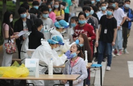 Of the 57 new cases logged by Chinese authorities on Sunday, 36 were domestic infections in the capital. PHOTO: AFP