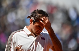 (FILES) This file photo taken on June 07, 2019 shows Switzerland's Roger Federer during his men's singles semi-final match of The Roland Garros 2019 French Open tennis tournament in Paris. - Men's Grand Slam singles record-holder Roger Federer said on June 10, 2020 he would be sidelined until 2021 after undergoing keyhole surgery on his right knee. PHOTO: MARTIN BUREAU / AFP
