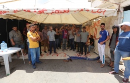 Unemployed workers block the road leading to the oil fields of Kamour during in a sit-in Tataouine on June 9, 2020, as they demand employment opportunities in oil companies. PHOTO: FATHI NASRI / AFP