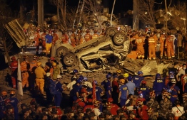 This photo taken on June 13, 2020 shows rescuers searching for survivors in the rubble of a building damaged by a tanker explosion near Wenling, in China's eastern Zhejiang province. The number of people killed in a tanker truck explosion on a highway in eastern China has climbed to 18, with nearly 200 more injured, local authorities said on June 14. PHOTO: AFP