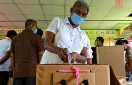 A voter casts his vote during a mock election to test the guidelines implemented against the COVID-19 coronavirus in Ingiriya of Kalutara District in Western Province on June 14, 2020. PHOTO: AFP