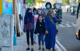 Pedestrians wearing face masks after the government lifted lockdown measures in the capital city of Male'. AHMED AWSHAN ILYAS/ MIHAARU