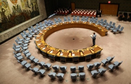 (FILES) In this file photo taken on September 20, 2017 an official looks at the empty chairs of leaders ahead of their participation in an open debate of the United Nations Security Council in New York. - The UN General Assembly on June 17, 2020 will elect five new members of the Security Council for 2021 and 2022, with battles underway for the Western and African seats. (Photo by Stephane LEMOUTON / POOL / AFP)