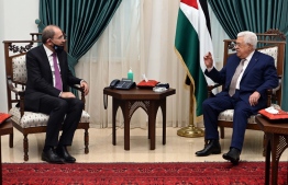 A handout picture provided by the Palestinian Authority's press office (PPO) on June 18, 2020 shows Palestinian president Mahmud Abbas (R) meeting with Jordan's Foreign Minister Ayman Safadi (L), clad in mask due to the COVID-19 coronavirus pandemic, in the West Bank city of Ramallah. (Photo by Thaer GHANAIM / PPO / AFP) / 