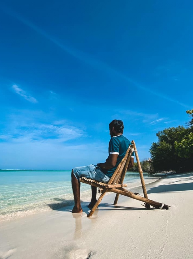 ށ.ފުނަދޫގެ ސަންރައިޒް ބީޗު: މޫދު ކައިރީގައި އޮނުން ތައްޔާރުކޮށްފައި ހުރި ގޮނޑިއެއްގައި މީހަކު އިށީނދެލައިގެން.-- ފޮޓޯ: ލައިފް އޮފް ރޮންޑޯ