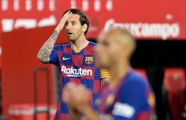 Barcelona's Argentinian forward Lionel Messi reacts after missing a goal opportunity during the Spanish league football match between Sevilla FC and FC Barcelona at the Ramon Sanchez Pizjuan stadium in Seville on June 19, 2020. (Photo by CRISTINA QUICLER / AFP)