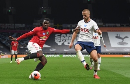 Manchester United's French midfielder Paul Pogba (L) vies for the ball against Tottenham Hotspur's English defender Eric Dier (R) during the English Premier League football match between Tottenham Hotspur and Manchester United at Tottenham Hotspur Stadium in London, on June 19, 2020. PHOTO: SHAUN BOTTERILL / AFP