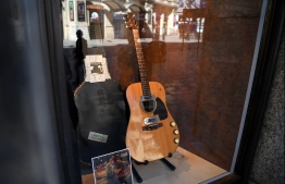 (FILES) In this file photo taken on May 15, 2020 The guitar used by musician Kurt Cobain during Nirvana's famous MTV Unplugged in New York concert in 1993, is displayed in the window of the Hard Rock Cafe Piccadilly Circus in central London prior to the auction of the guitar in Beverly Hills in June. - The guitar that grunge rock icon Kurt Cobain played during his legendary 1993 MTV Unplugged performance sold Saturday for a record $6 million, the auction house said. (Photo by DANIEL LEAL-OLIVAS / AFP)