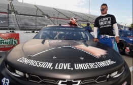 (FILES) In this file photo Bubba Wallace, driver of the #43 Richard Petty Motorsports Chevrolet, wears a "I Can't Breathe - Black Lives Matter" t-shirt under his firesuit stands next to his car painted with "#Black Lives Matter" prior to the NASCAR Cup Series Blue-Emu Maximum Pain Relief 500 at Martinsville Speedway on June 10, 2020 in Martinsville, Virginia. - NASCAR said Sunday night, June 21, that a noose was found in driver Bubba Wallaceís garage stall at Talladega Superspeedway in Alabama, and they have launched a probe of the "heinous" act. (Photo by Jared C. Tilton / GETTY IMAGES NORTH AMERICA / AFP)