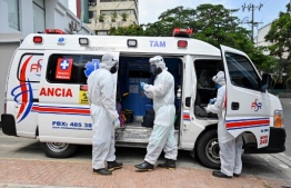 Health workers move a recovered novel coronavirus patient from the Versalles clinic to her home on June 24, 2020, in Cali, Colombia. - Colombia extended its quarantine Tuesday until July 15, as its COVID-19 cases continue to climb. The country has registered 2,404 deaths out of more than 73,500 cases. (Photo by Luis ROBAYO / AFP)