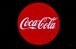 (FILES) This file photo taken on January 19, 2016 shows the logo of the Coca-Cola company during the presentation of a new advertising campaign in Paris. - Coca-Cola, a major force in global advertising, announced on June 26, 2020 that it would suspend ads on social media for at least 30 days, as platforms face a reckoning over how they deal with racist content. (Photo by PATRICK KOVARIK / AFP)