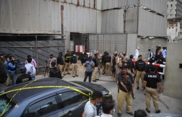 Security personnel guard the main entrance of the Pakistan Stock Exchange building in Karachi on June 29, 2020. - Gunmen attacked the Pakistan Stock Exchange in Karachi on June 29, with four of the assailants killed, police said. (Photo by Asif HASSAN / AFP)