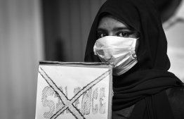 A protestor holding a signboard during a demonstration against sexual abuse. PHOTO: NISHAN ALI/ MIHAARU