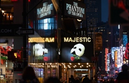 (FILES) In this file photo signage of the Broadway play "The Phantom of the Opera" is seen at Time Square on March 12, 2020 in New York City. - Broadway theaters will remain closed until at least the end of May 2021. (Photo by Angela Weiss / AFP)