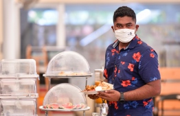 A customer in a cafe' located in the capital city of Male'. The Restaurant Association of Maldives (RAM), has asserted that it had no intentions to undermine the operation of local home-based cooks in Maldives. PHOTO: NISHAN ALI/ MIHAARU