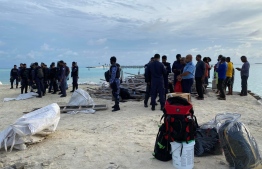 Police officers during the operation on B. Bodufinolhu to deescalate the situation after expatriate workers held local staff captive, protesting over six months of unpaid salaries. PHOTO/POLICE