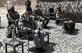 In this handout photograph taken on July 3, 2020 and released by the Indian Press Information Bureau (PIB), India's Prime Minister Narendra Modi (L) sits during a briefing with military commanders as he arrives in Leh, the joint capital of the union territory of Ladakh. - Prime Minister Narendra Modi made a surprise visit to India's northern frontier region with China on July 3 in his first trip to the area since a deadly border clash last month. (Photo by Handout / PIB / AFP) / 