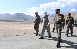 In this handout photograph taken on July 3, 2020 and released by the Indian Press Information Bureau (PIB), India's Prime Minister Narendra Modi (C) walks with military commanders as he arrives in Leh, the joint capital of the union territory of Ladakh. (Photo by Handout / PIB / AFP) /