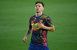 Barcelona's Argentine forward Lionel Messi warms up before the Spanish League football match between FC Barcelona and Club Atletico de Madrid at the Camp Nou stadium in Barcelona on June 30, 2020. (Photo by Lluis GENE / AFP)