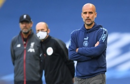 Manchester City's Spanish manager Pep Guardiola (R) watches from the touchline during the English Premier League football match between Manchester City and Liverpool at the Etihad Stadium in Manchester, north west England, on July 2, 2020. (Photo by LAURENCE GRIFFITHS / POOL / AFP) / RESTRICTED TO EDITORIAL USE. No use with unauthorized audio, video, data, fixture lists, club/league logos or 'live' services. Online in-match use limited to 120 images. An additional 40 images may be used in extra time. No video emulation. Social media in-match use limited to 120 images. An additional 40 images may be used in extra time. No use in betting publications, games or single club/league/player publications. / 