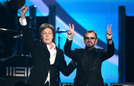 (FILES) In this file photo taken Musicians Paul McCartney (L) and Ringo Starr of The Beatles perform onstage during the 56th GRAMMY Awards at Staples Center on January 26, 2014 in Los Angeles, California. - Ringo Starr held an online 80th birthday bash June 7 with a little help from his celebrity friends -- and a number of classic Beatles songs -- in aid of causes including Black Lives Matter. PHOTO: KEVORK DJANSEZIAN / GETTY IMAGES NORTH AMERICA / AFP