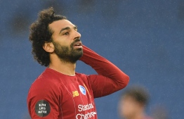 Liverpool's Egyptian midfielder Mohamed Salah reacts during the English Premier League football match between Brighton and Hove Albion and Liverpool at the American Express Community Stadium in Brighton, southern England on July 8, 2020. (Photo by DANIEL LEAL-OLIVAS / POOL / AFP)