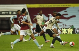 Manchester United's English striker Marcus Rashford (R) shoots at goal during the English Premier League football match between Aston Villa and Manchester United at Villa Park in Birmingham, central England on July 9, 2020. PHOTO: ANDREW BOYERS / POOL / AFP