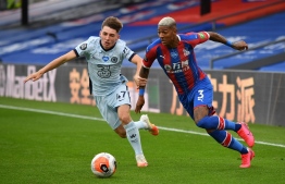 Chelsea's Scottish midfielder Billy Gilmour (L) challenges Crystal Palace's Dutch defender Patrick van Aanholt (R) during the English Premier League football match between Crystal Palace and Chelsea at Selhurst Park in south London on July 7, 2020. PHOTO: JUSTIN TALLIS / POOL / AFP