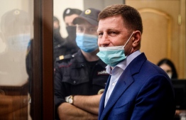 Russia's Khabarovsk region governor Sergei Furgal, charged with organising "the murders and the attempted murder of a number of entrepreneurs" in 2004 and 2005, stands inside a defendants' cage during a court hearing in Moscow on July 10, 2020. PHOTO: DIMITAR DILKOFF / AFP