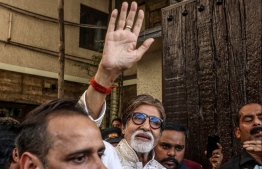 (FILES) In this file photo taken on October 10, 2019 Bollywood actor and producer Amitabh Bachchan waves to fans gathered outside his residence to celebrate his 77th birthday in Mumbai. - Bollywood veteran megastar Amitabh Bachchan, 77, has tested positive for COVID-19 and was admitted to hospital on July 11, 2020, in his hometown of Mumbai, he said on Twitter, calling for those close to him to get tested. PHOTO: STR / AFP
