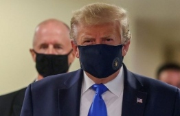 US President Donald Trump pictured wearing a face mask in public for the first time on July 11, 2020. PHOTO/REUTERS