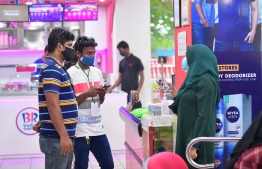 A shop clerk wearing protective gear as a precautionary measure against COVID-19 as Maldives transitions to the 'new normal'. The number of daily virus cases recorded in the country has spiked after the state eased lockdown restrictions. PHOTO: MIHAARU