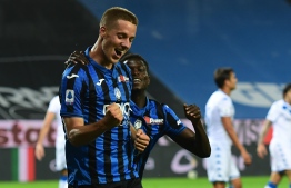 Atalanta's Croatian midfielder Mario Pasalic is congratulated by Atalanta's Gambian midfielder Ebrima Colley after scoring his team sixth goal during the Italian Serie A football match Atalanta vs Brescia played on July 14, 2020 behind closed doors at the Atleti Azzurri d'Italia stadium in Bergamo, as the country eases its lockdown aimed at curbing the spread of the COVID-19 infection, caused by the novel coronavirus. (Photo by MIGUEL MEDINA / AFP)