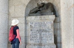 A visitor looks at the decapitated bust of Cecil John Rhodes, a 19th-century British colonialist, at the Rhodes Memorial in Cape Town on July 15, 2020. PHOTO: RODGER BOSCH / AFP