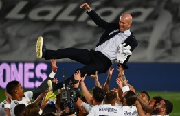 Real Madrid's player toss Real Madrid's French coach Zinedine Zidane after winning the Liga title after the Spanish League football match between Real Madrid CF and Villarreal CF at the Alfredo di Stefano stadium in Valdebebas, on the outskirts of Madrid, on July 16, 2020. (Photo by GABRIEL BOUYS / AFP)