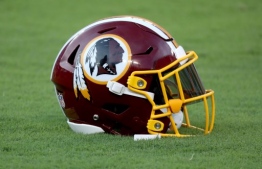 (FILES) In this file photo a Washington Redskins helmet sits on the grass before the start of the Redskins and Baltimore Ravens preseason game at M&T Bank Stadium on August 30, 2018 in Baltimore, Maryland. - The Washington Redskins launched an independent investigation on July 16, 2020 after 15 female former employees alleged they had been subjected to sexual harassment during their time at the club. A Washington Post report said the allegations spanned a 13-year period from 2006 to 2019 and had already led to the departure of three team employees in the past week. (Photo by Rob Carr / GETTY IMAGES NORTH AMERICA / AFP)