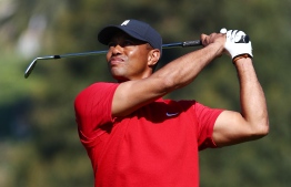 (FILES) In this file photo Tiger Woods of the United States plays a shot on the 10th hole during the final round of the Genesis Invitational on February 16, 2020 in Pacific Palisades, California. - A two-part documentary detailing the rise, fall and epic comeback of 15-time major golf champion Tiger Woods will debut in December, producers announced July 9, 2020. Rachel Uchitel, who was at the center of a sex scandal that erupted around Woods in November 2009, will be "breaking her silence for the first time" in the film, according to a release announcing the project. (Photo by Tim Bradbury / GETTY IMAGES NORTH AMERICA / AFP)